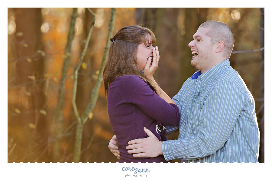boy and girl laughing during engagement session