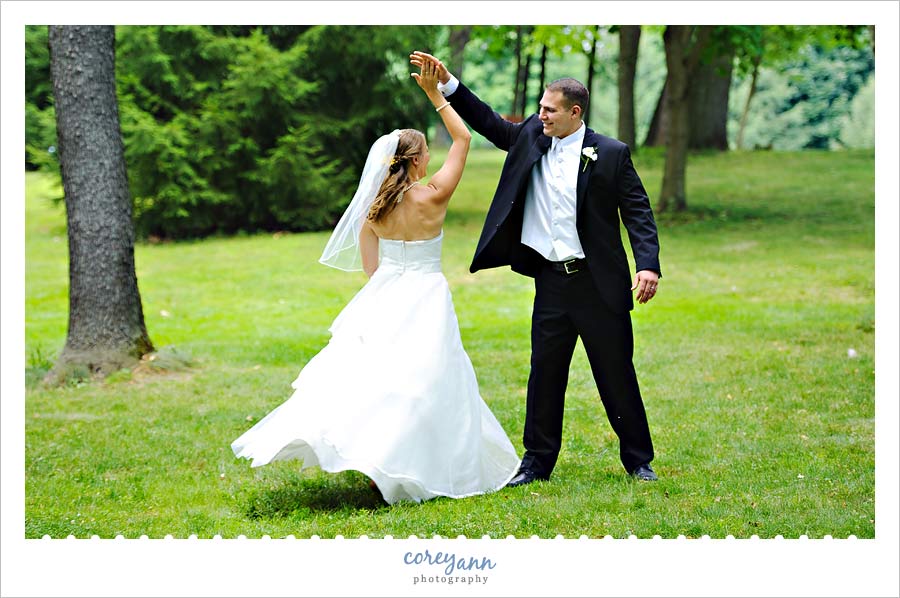 Chrissanna and Robert's Wedding in Akron bride and groom twirling outside in grass