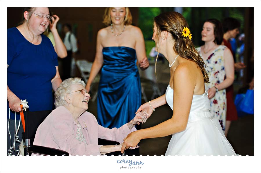 Chrissanna and Robert's Wedding in Akron bride dancing with grandma in wheelchair at reception