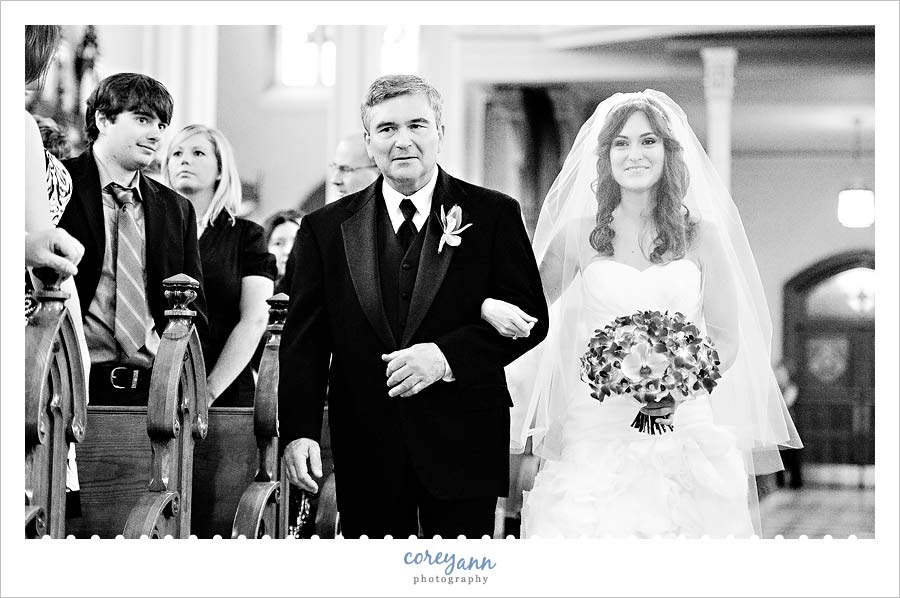 bride and her father walking down the aisle at st stephen roman catholic church