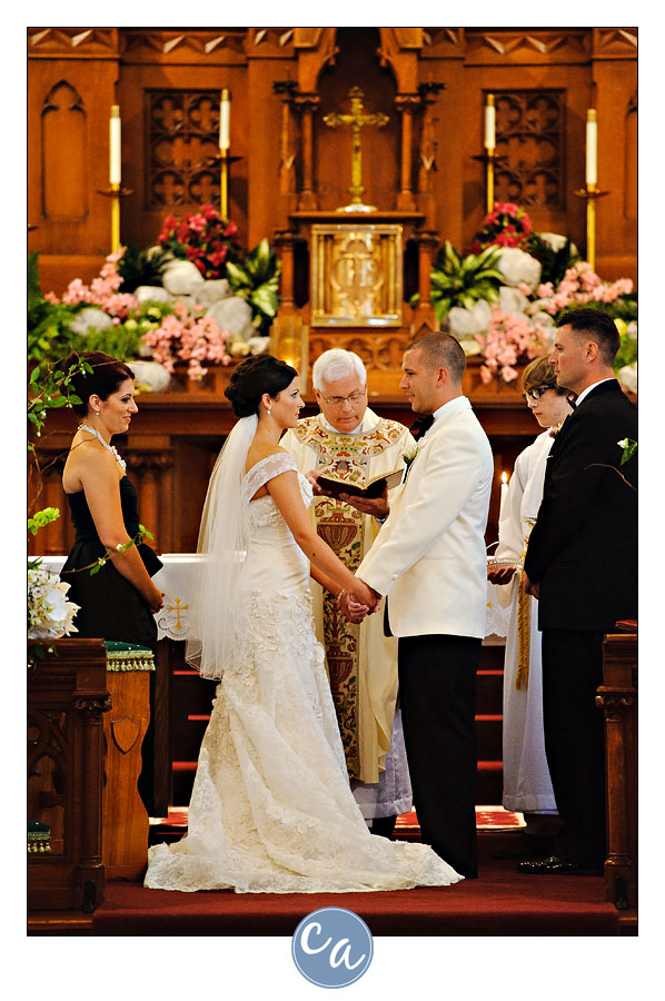 bride and groom holding hands during vows at holy trinity in avon