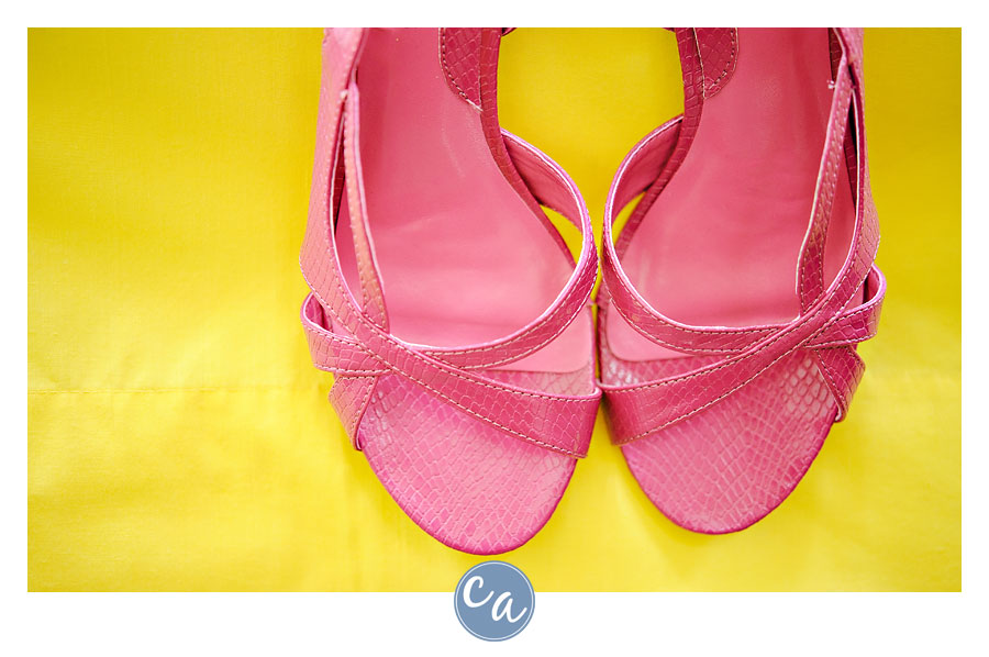 pink wedding shoes on a yellow backdrop