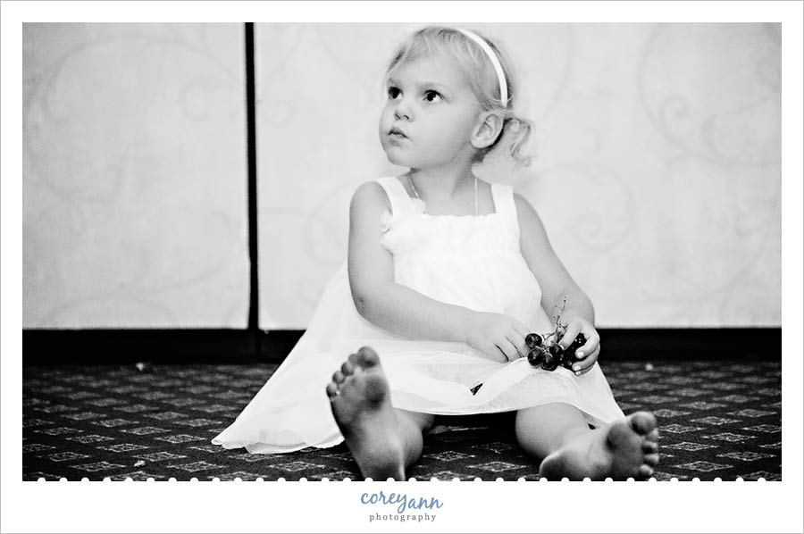 Emily and Jason's Wedding flower girl on the floor with dirty feet at the reception