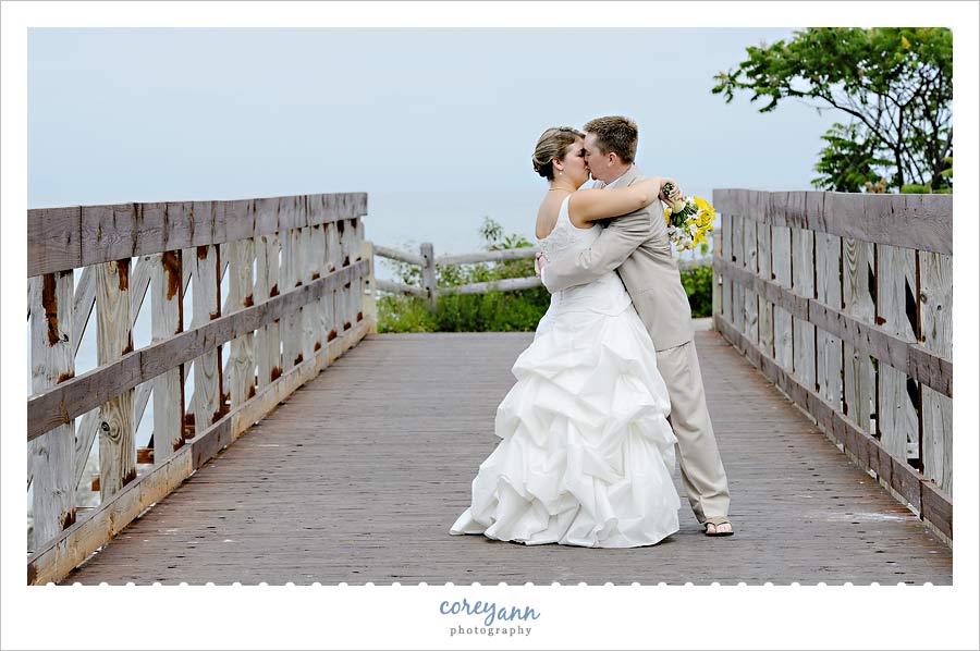 Emily and Jason's Wedding bride and groom kissing on a bridge