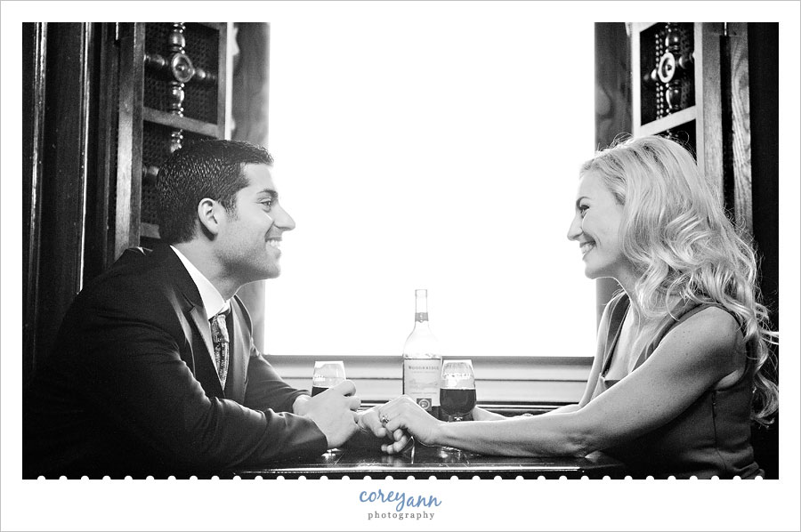 couple sharing a glass of wine during engagement session