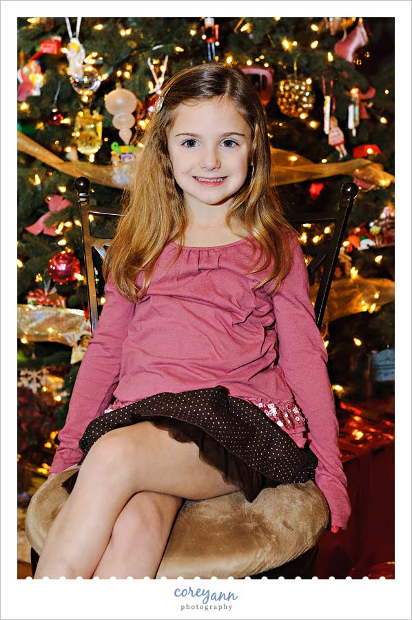 5 year old in front of the christmas tree