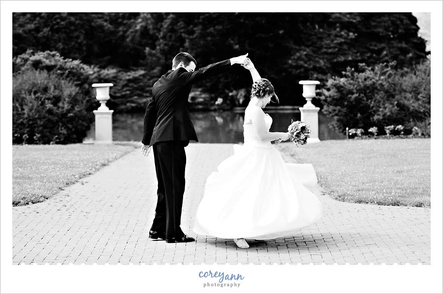 groom twirling bride in her wedding dress outside in mansfield ohio