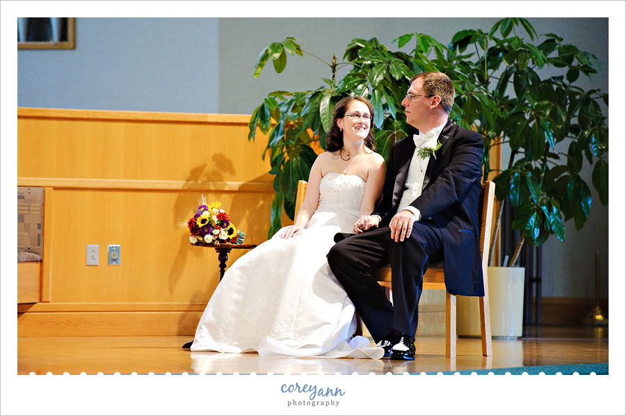 bride and groom looking at each other during catholic ceremony