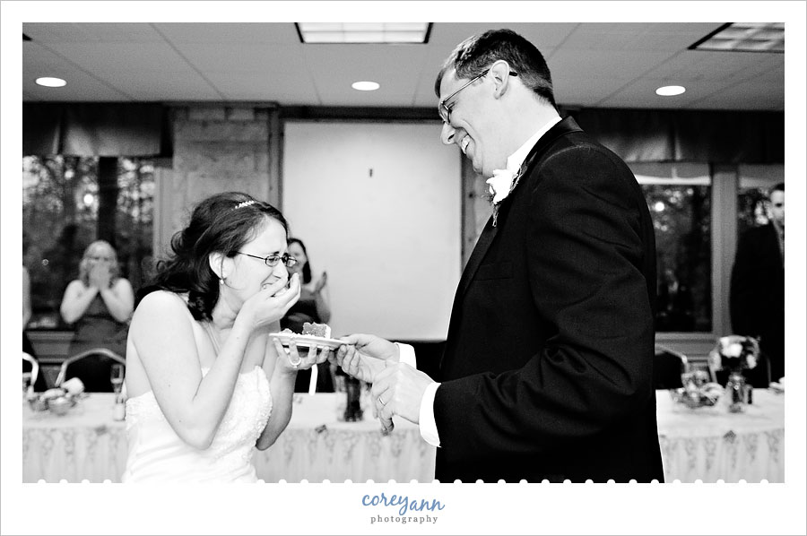 bride and groom during cake cutting at reception