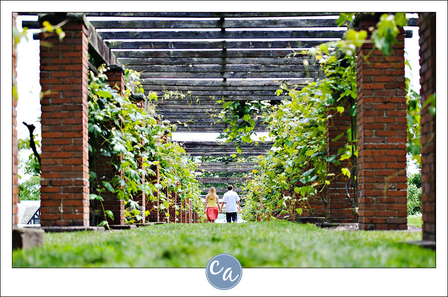 couple walking grape arbor at stan hywet