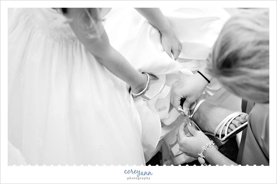 bride having her shoes put on in sugarcreek ohio