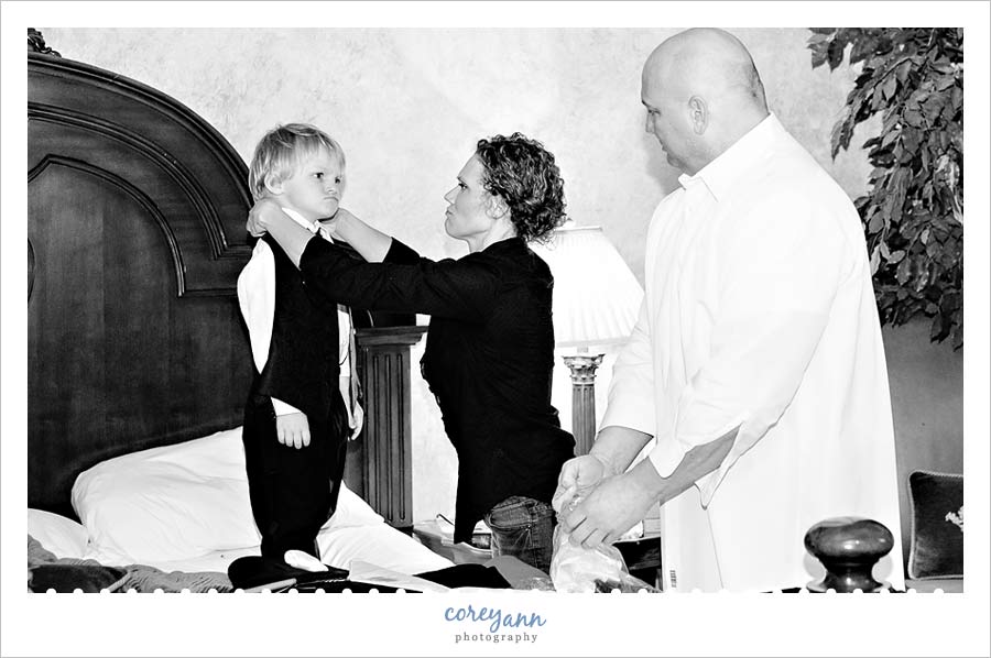 ring bearer frowning while getting dressed at Landoll's Mohican Castle