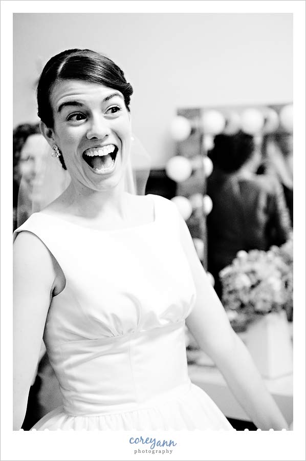 bride smiling while getting ready at the old stone church