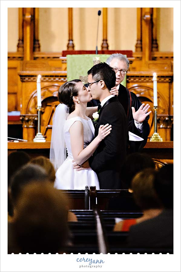 first kiss at wedding ceremony at old stone church in Cleveland ohio