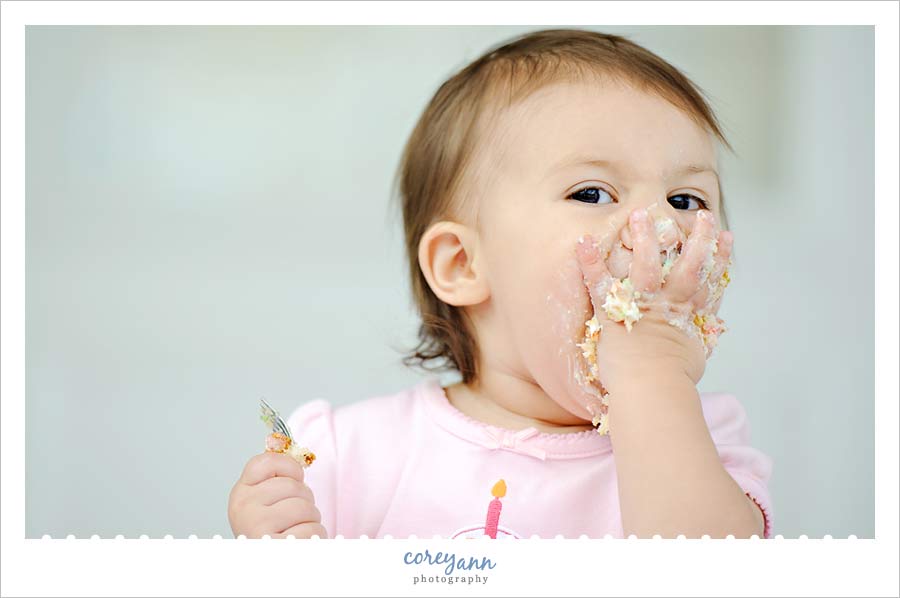 Miss Margaux | 1 Year child eating cake for birthday picture