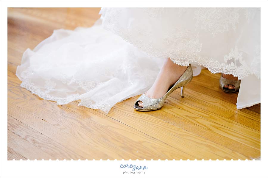 bride slipping her shoes on 