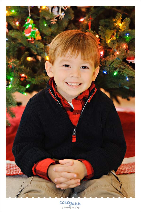 child portrait in front of christmas tree in avon ohio