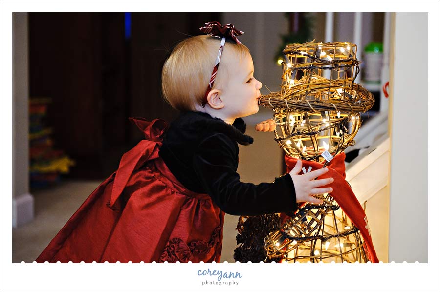one year old kissing a lit up snowman