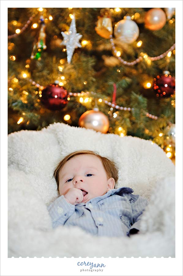 two month old baby in front of Christmas tree