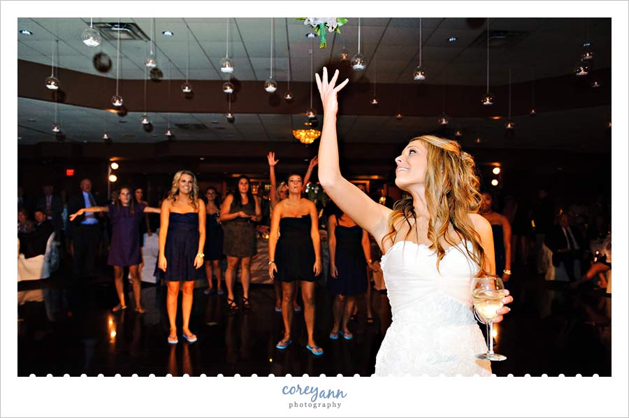 bouquet toss at reception at buhl park at avalon lakes 
