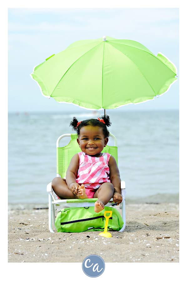 one year old in beach chair on the beach