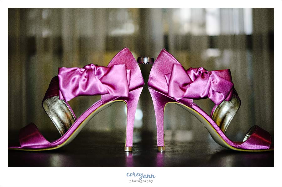 wedding ring balanced on pink high heels