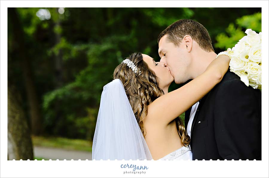 bride and groom kissing for portraits at canton garden center