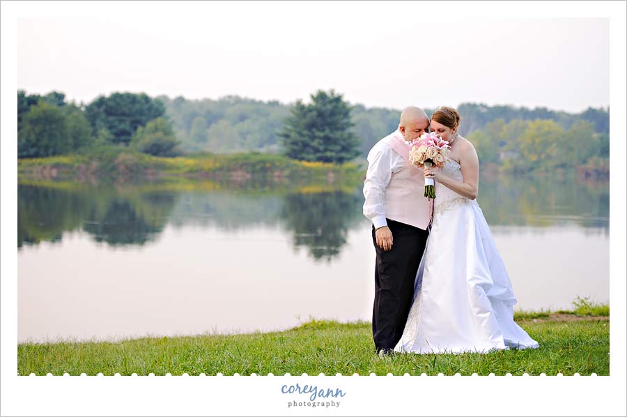 bride and groom smelling flowers after ceremony in alliance ohio