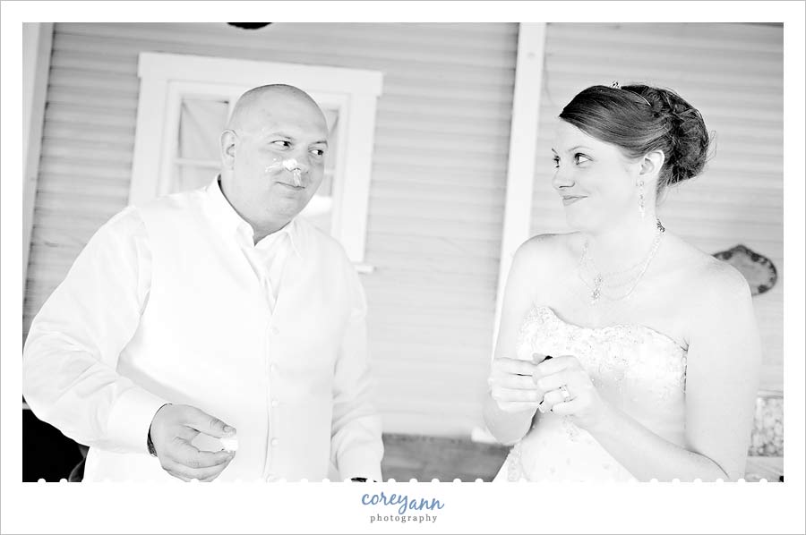 groom giving bride a dirty look after the cake cutting 