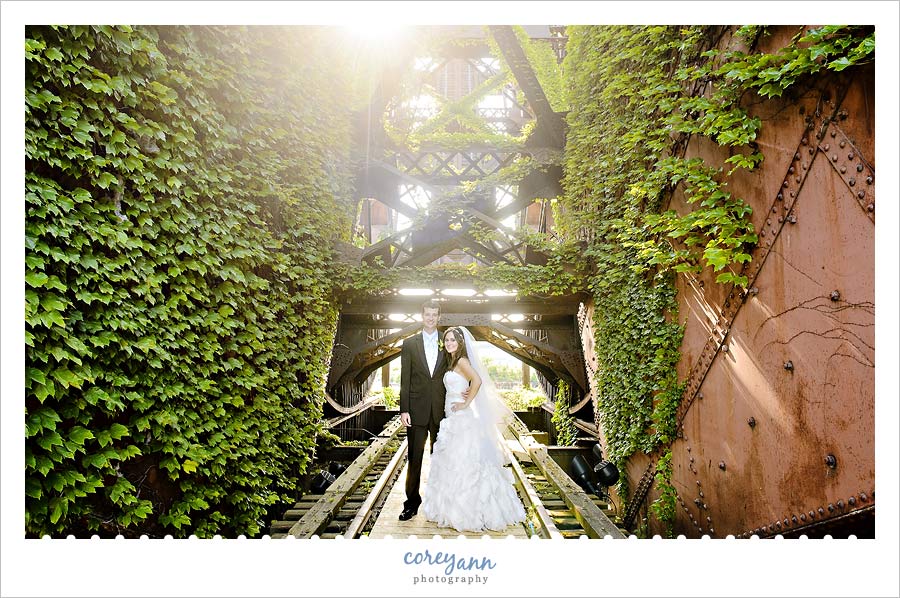 bride and groom on old iron bridge near shooters in cleveland ohio