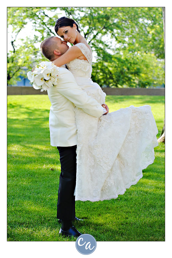 groom picking bride up outside