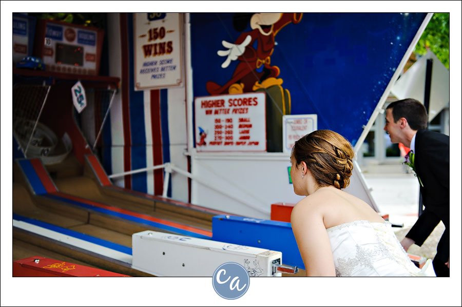 bride and groom playing skee ball