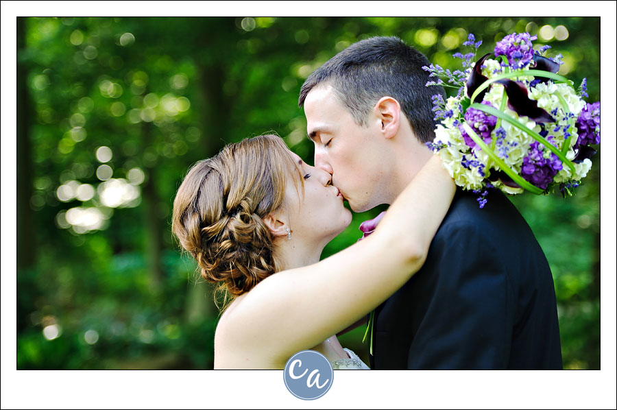 bride and groom kissing outside in the summer