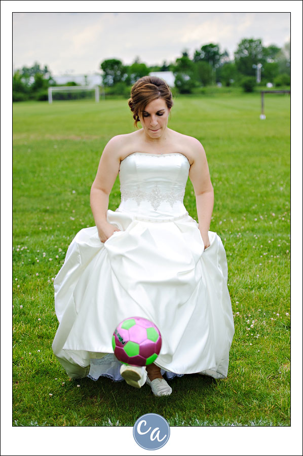 bride playing soccer in wedding dress