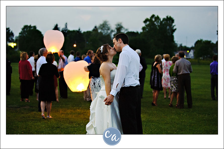 bride and groom kissing during wish lantern release