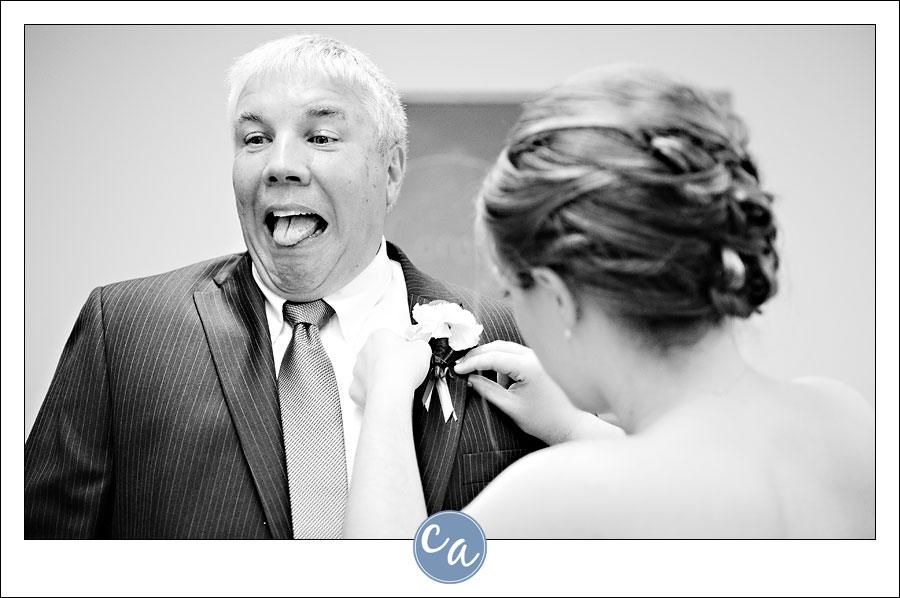 bride pinning boutonniere on her father
