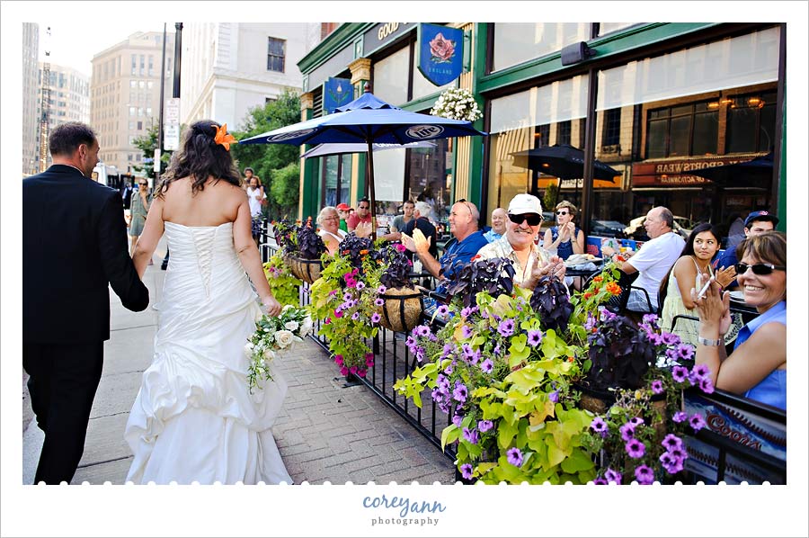 crowd clapping for bride and groom on east 4th street in cleveland
