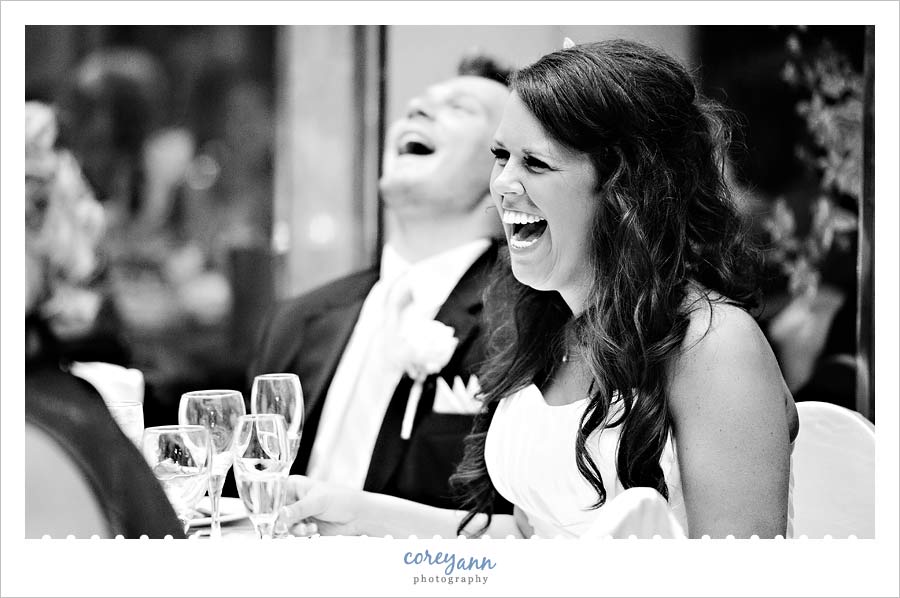 bride and groom laughing during toasts 