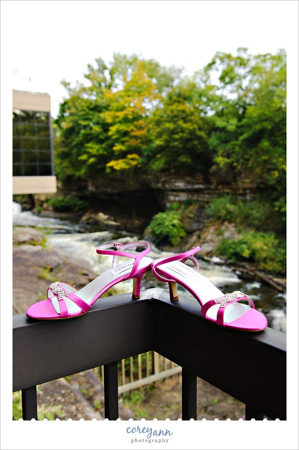 pink wedding shoes outside near waterfalls