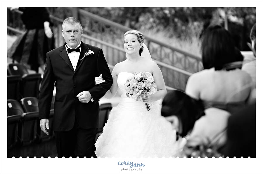 bride walking down aisle with her father