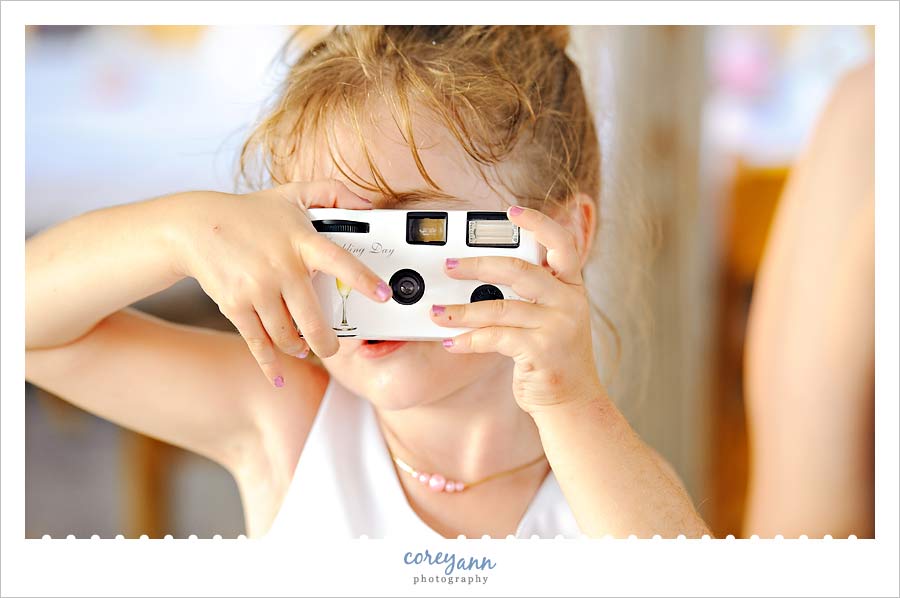 flower girl taking a picture with an instant camera