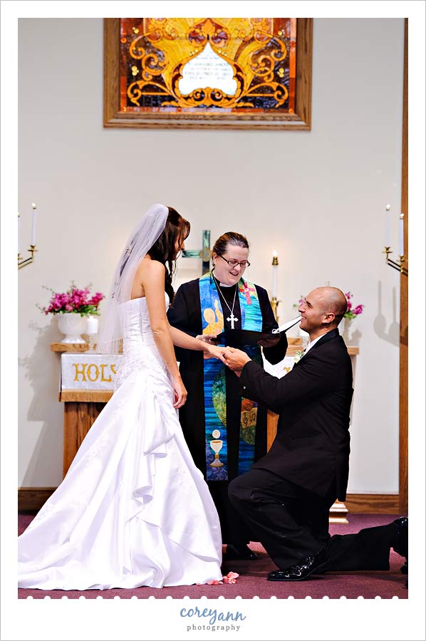 groom on one knee during ceremony