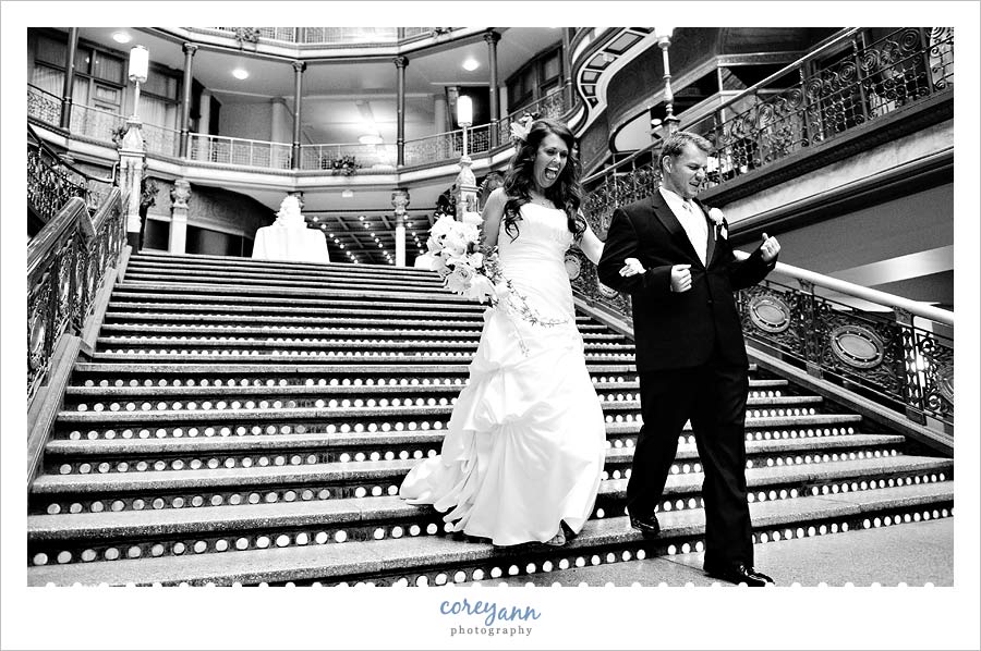 bride and groom making funny faces during entrance into hyatt arcade
