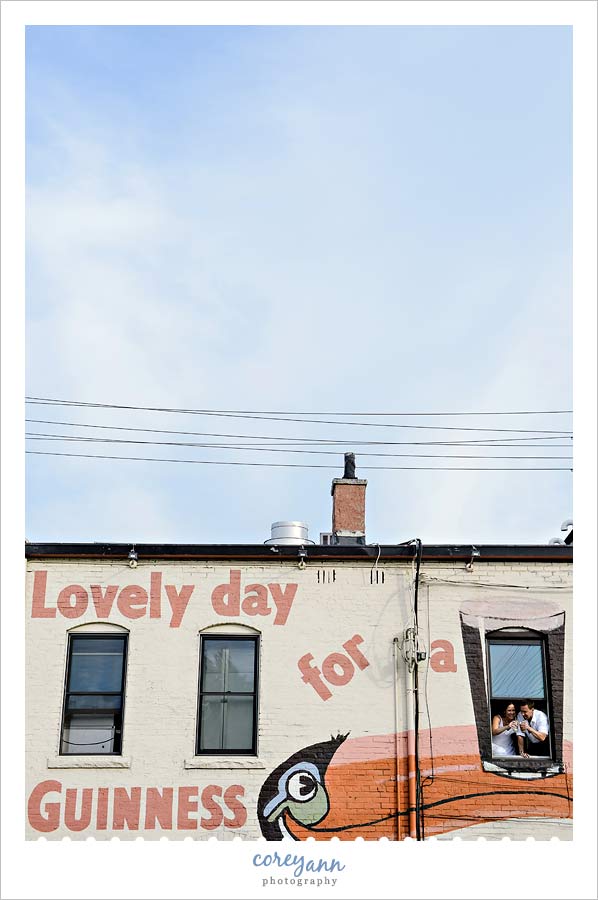 bride and groom drinking guinness in window at the treehouse in cleveland