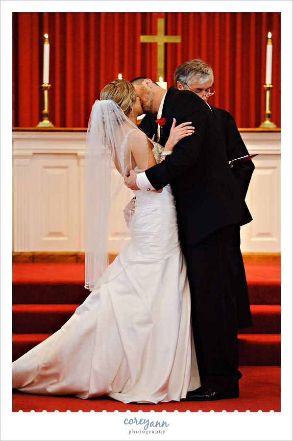 bride and groom first kiss at la porte methodist church