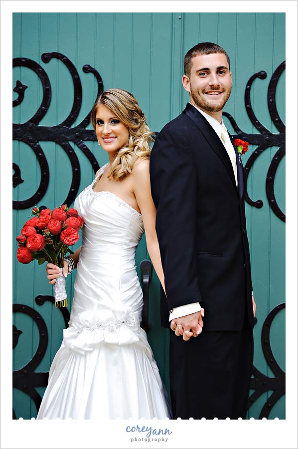 bride and groom in front of blue door