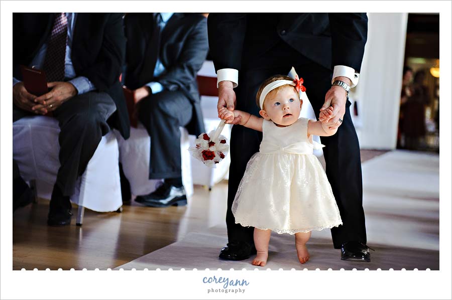 9 month old flower girl walking down the aisle