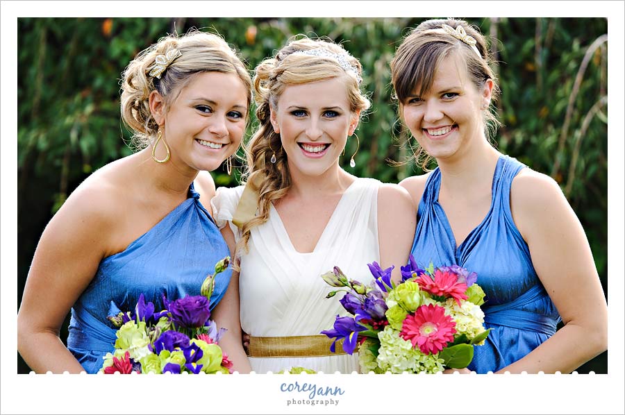 bridesmaids in blue with multi colored bouquets