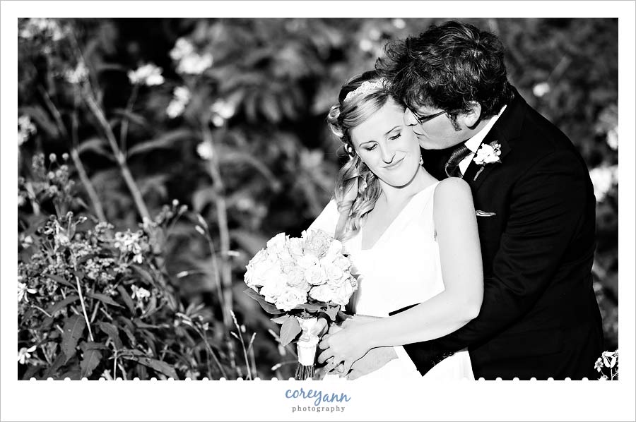 groom kissing bride after wedding at kirtland country club