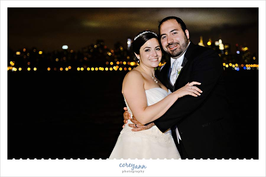 bride and groom with NYC skyline at night